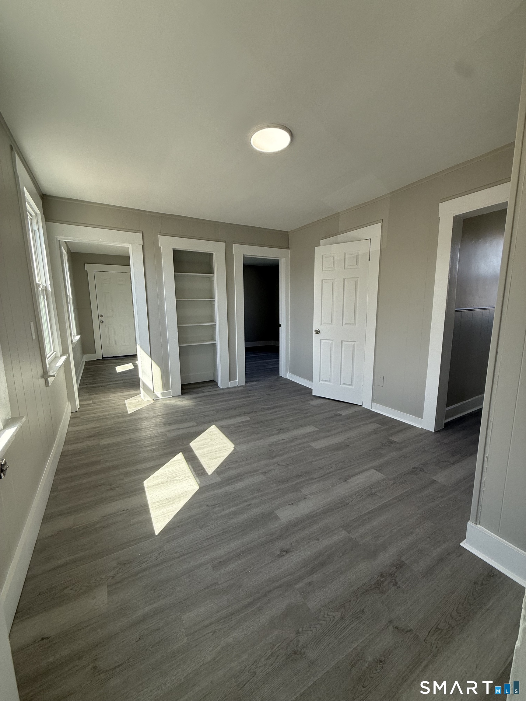 420 Short Beach Road East Haven, CT 06512 - Photo 12 of 23 wooden floor in a hall with an empty room