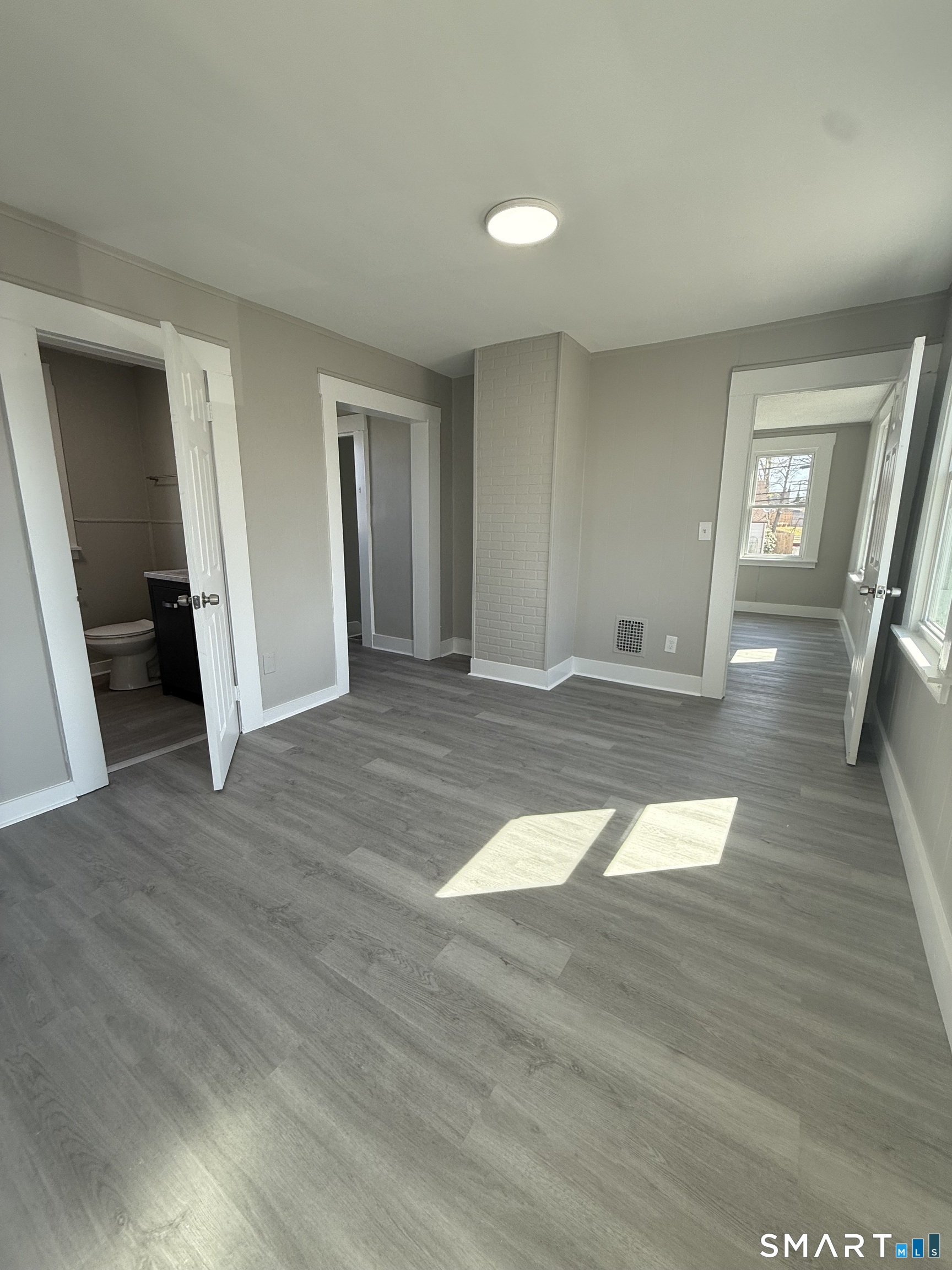 420 Short Beach Road East Haven, CT 06512 - Photo 13 of 23 a view of empty room with wooden floor and window