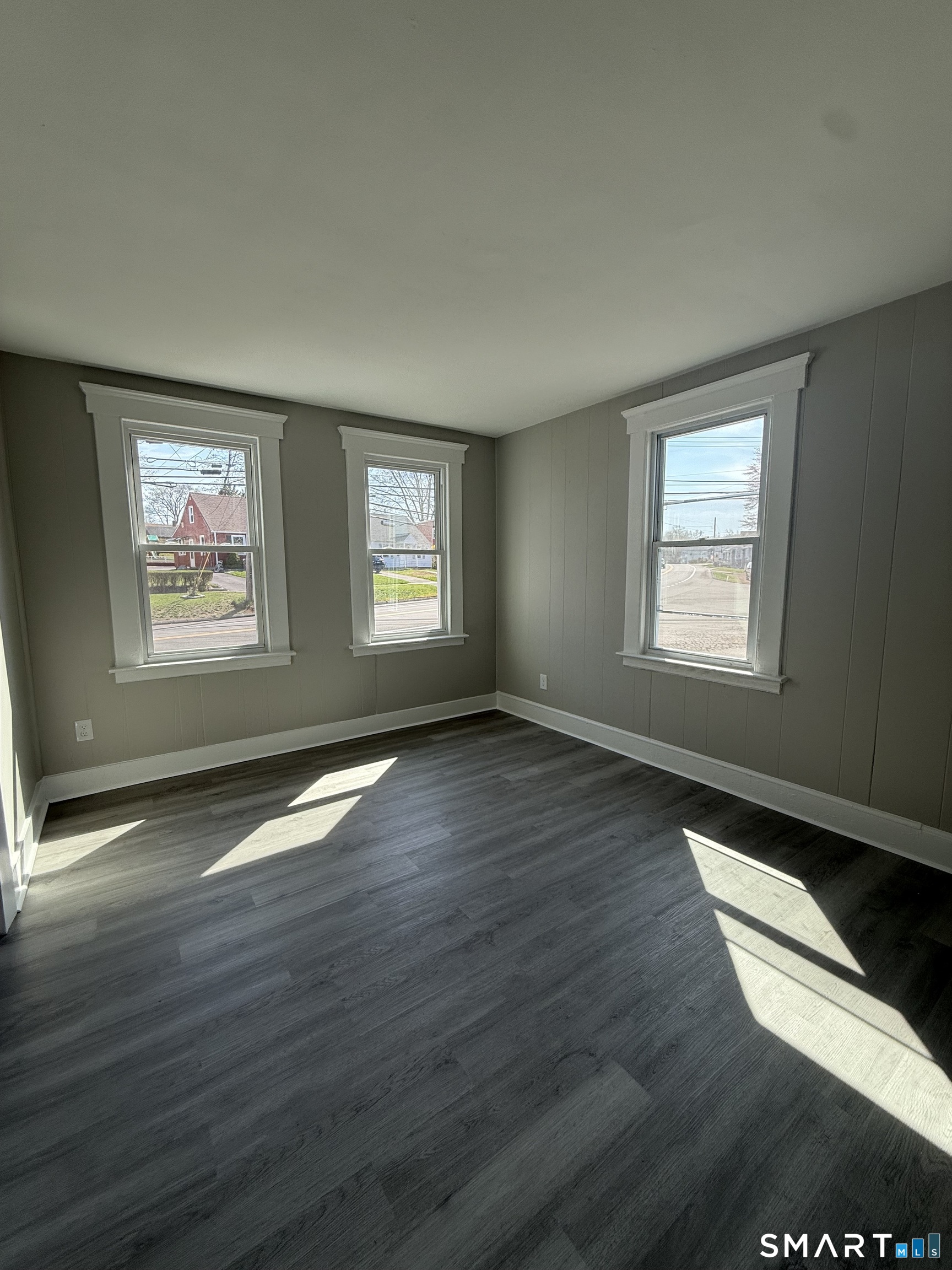 420 Short Beach Road East Haven, CT 06512 - Photo 16 of 23 an empty room with wooden floor and windows