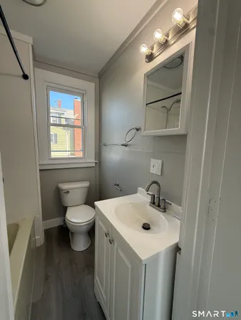 a bathroom with a sink mirror and toilet