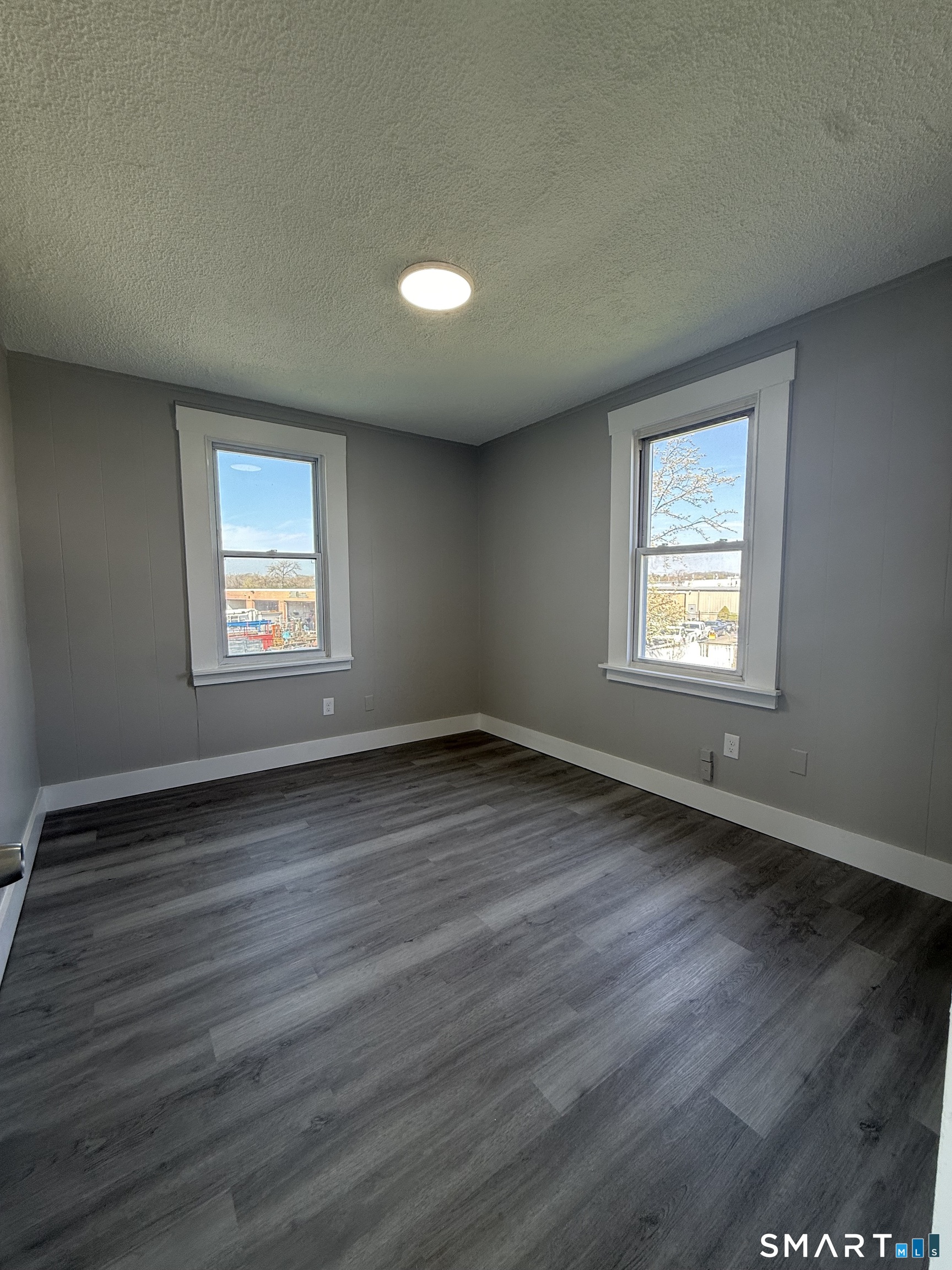 420 Short Beach Road East Haven, CT 06512 - Photo 18 of 23 an empty room with wooden floor and windows
