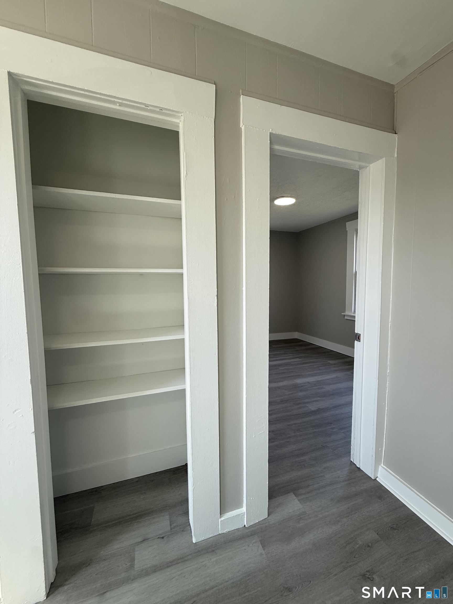 420 Short Beach Road East Haven, CT 06512 - Photo 20 of 23 a view of a hallway with wooden floor and closet