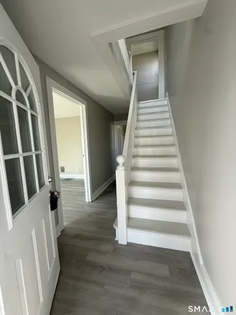 a view of an entryway with wooden floor
