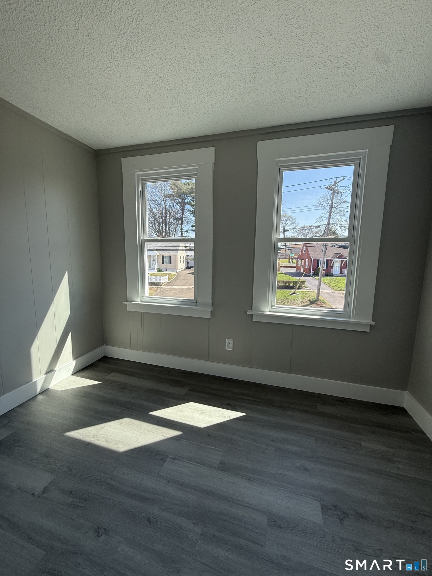 420 Short Beach Road East Haven, CT 06512 - Photo 21 of 23 a view of an empty room with wooden floor and a window