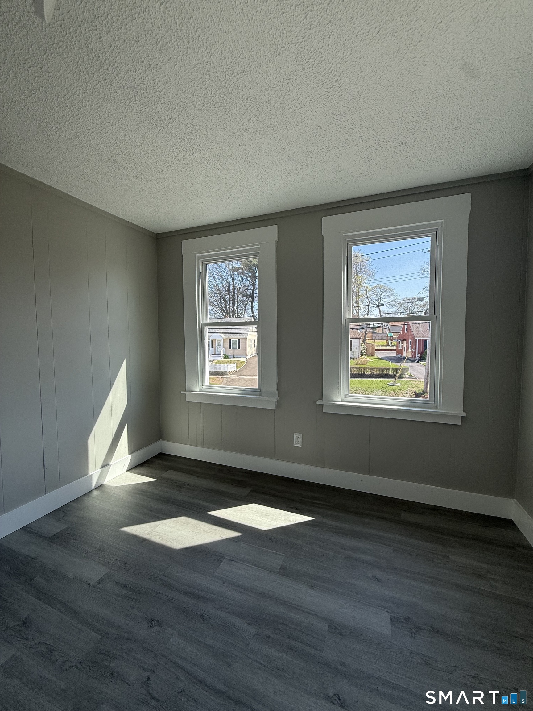 420 Short Beach Road East Haven, CT 06512 - Photo 22 of 23 a view of an empty room with wooden floor and a window