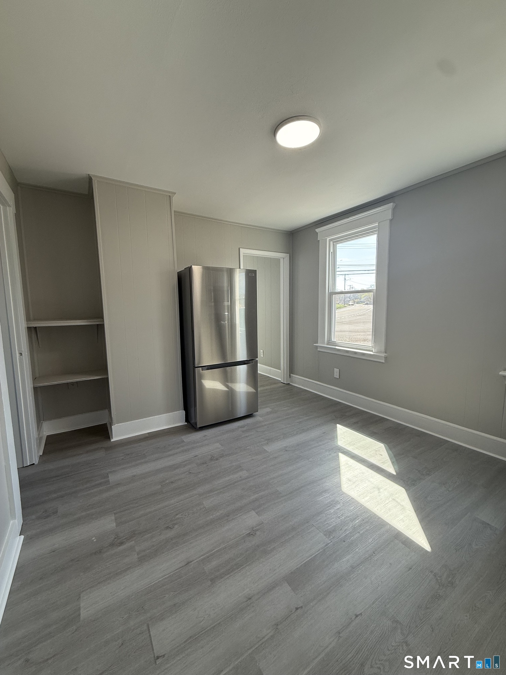 420 Short Beach Road East Haven, CT 06512 - Photo 5 of 23 a view of empty room with wooden floor and window