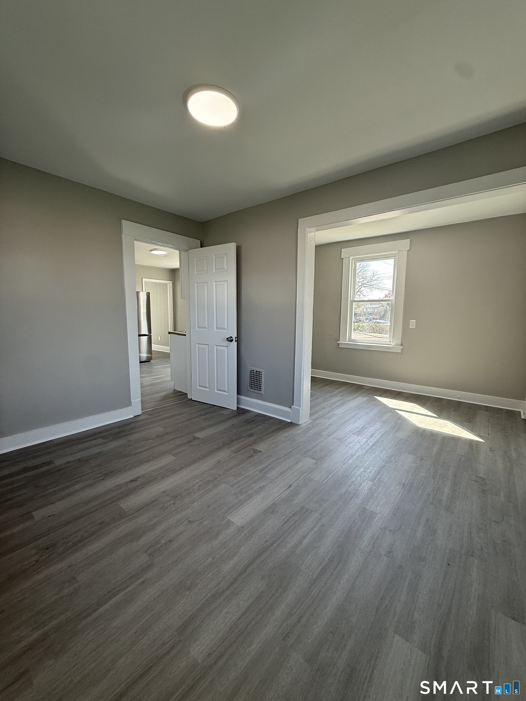 420 Short Beach Road East Haven, CT 06512 - Photo 6 of 23 an empty room with wooden floor and windows