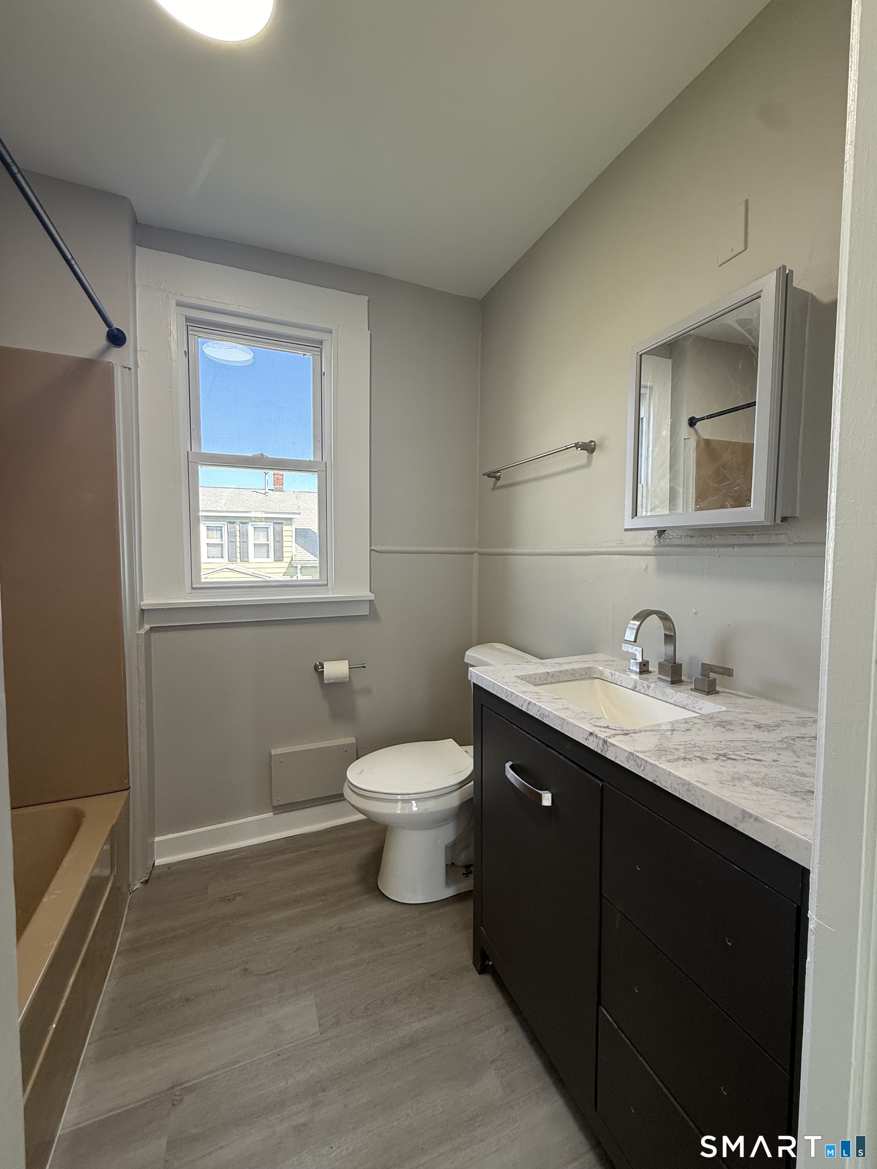 420 Short Beach Road East Haven, CT 06512 - Photo 8 of 23 a bathroom with a granite countertop toilet a sink and a mirror