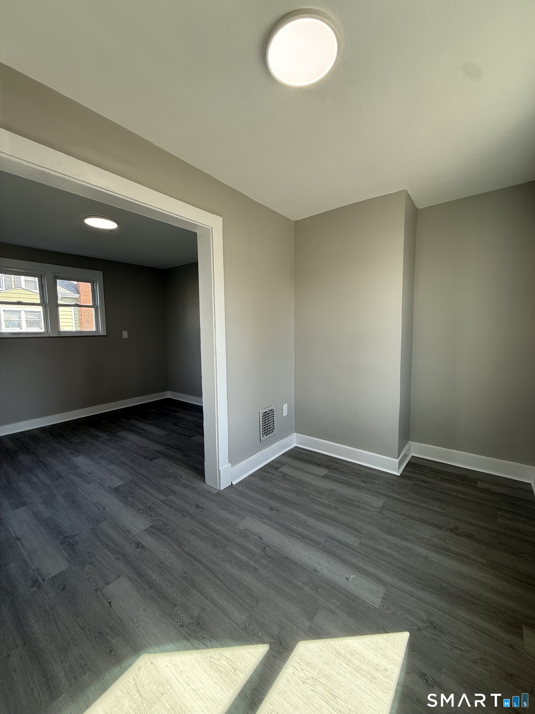 420 Short Beach Road East Haven, CT 06512 - Photo 9 of 23 an empty room with wooden floor and windows