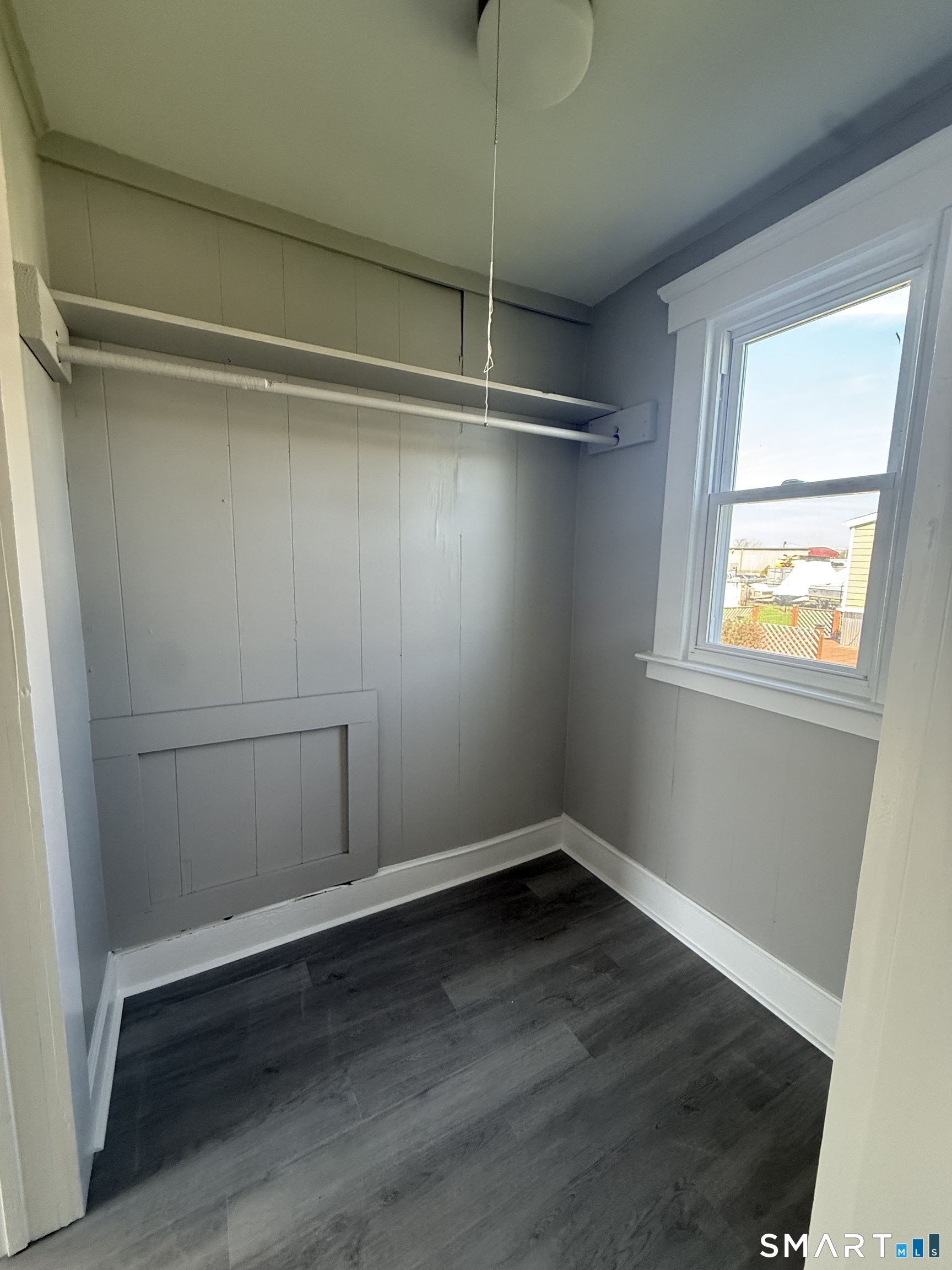 420 Short Beach Road East Haven, CT 06512 - Photo 10 of 23 a view of an empty room with wooden floor and a window