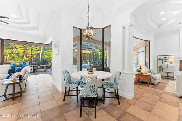 a kitchen with stainless steel appliances granite countertop a stove a refrigerator a oven a sink a dining table and chairs with wooden floor