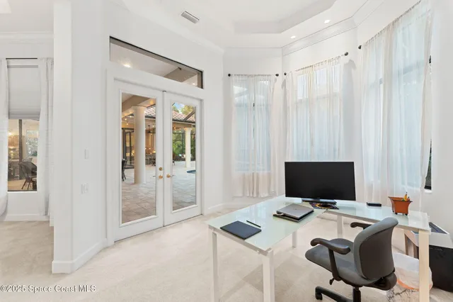 a living room with furniture and floor to ceiling windows