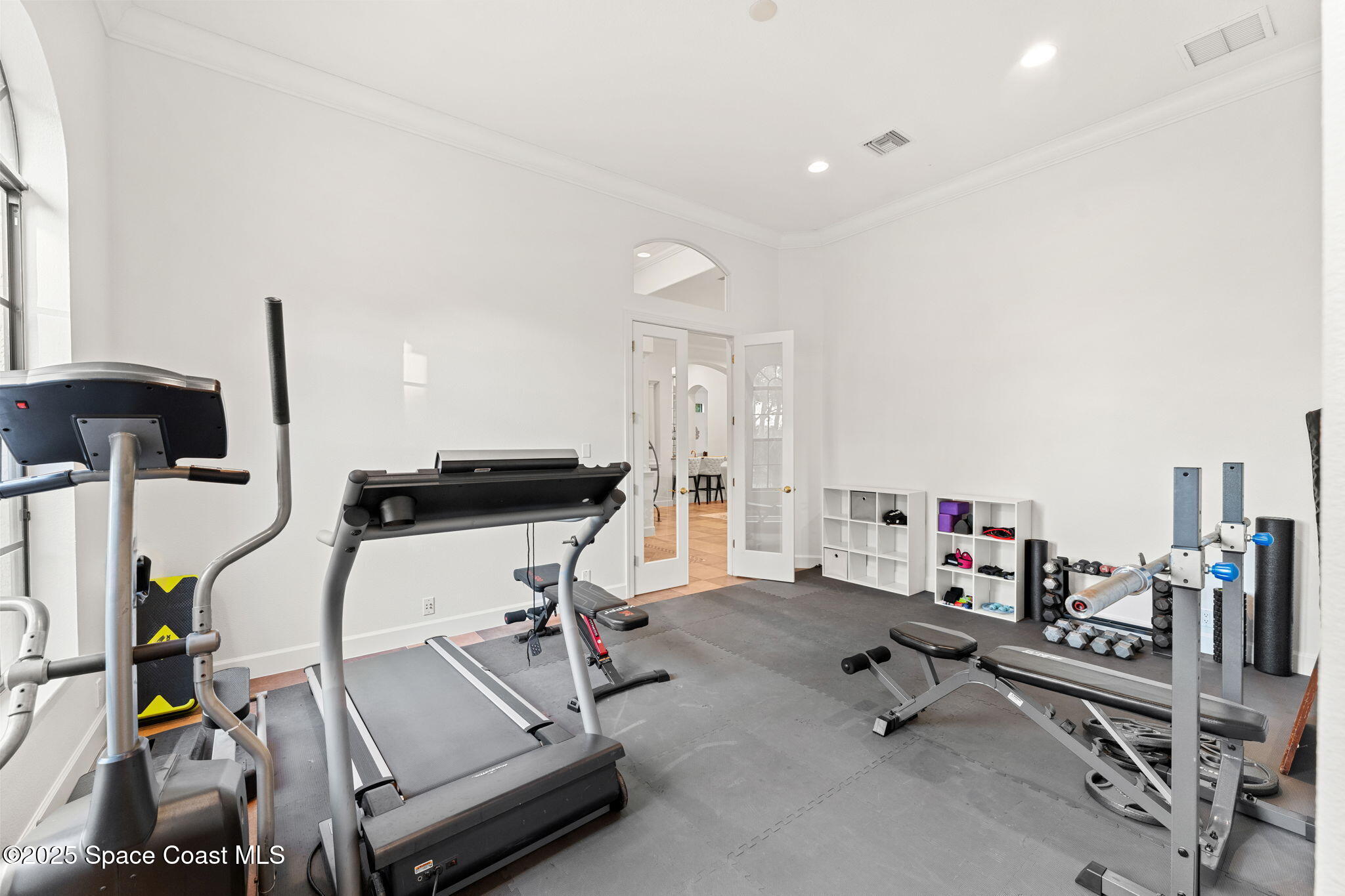 4447 Reseda Way Rockledge, FL 32955 - Photo 42 of 87 a room with gym equipment and a view of living room