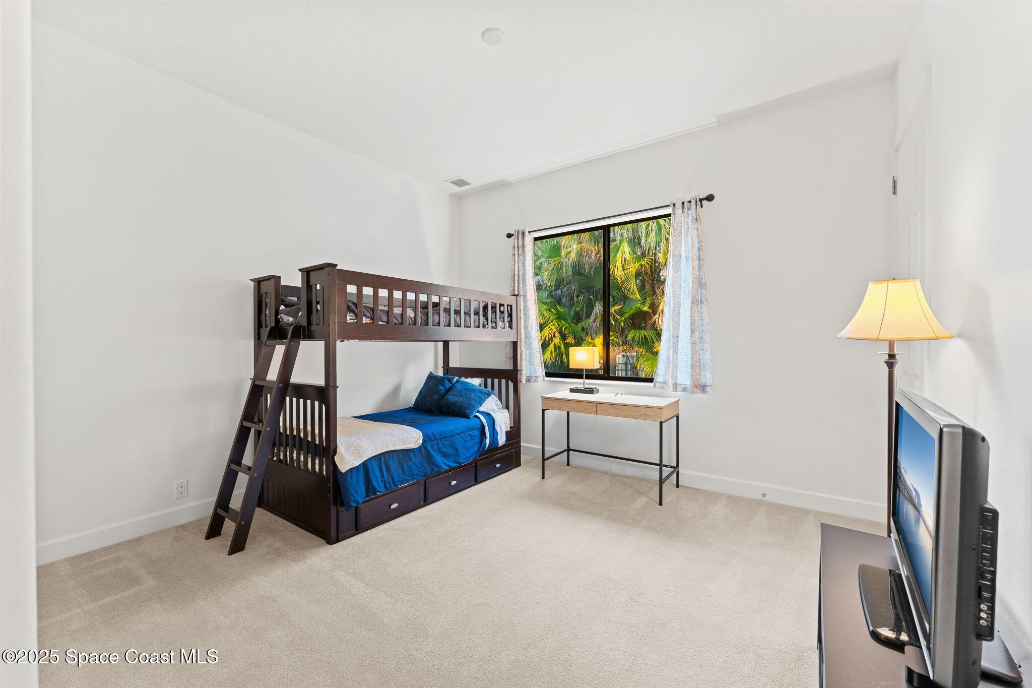 4447 Reseda Way Rockledge, FL 32955 - Photo 44 of 87 a bedroom with a bed and a chandelier