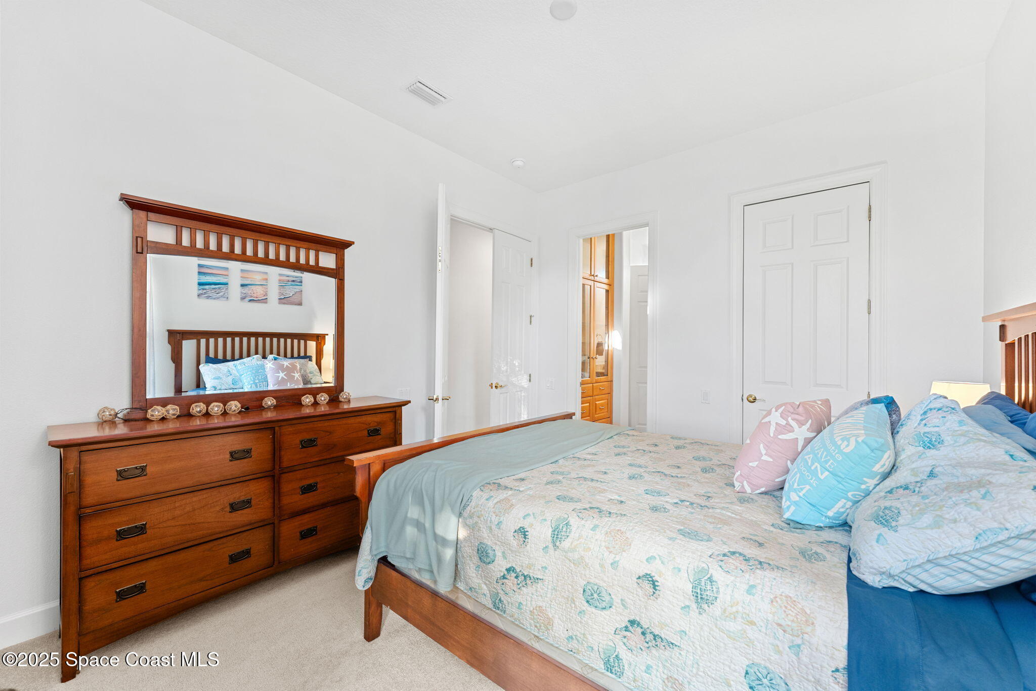 4447 Reseda Way Rockledge, FL 32955 - Photo 45 of 87 a bedroom with a bed and a dresser