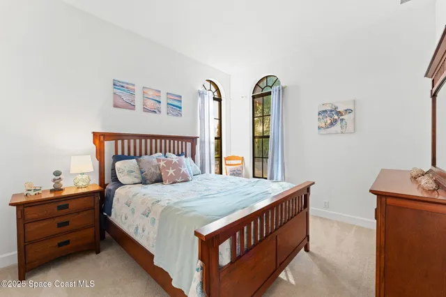 a view of a house with a yard and a tree