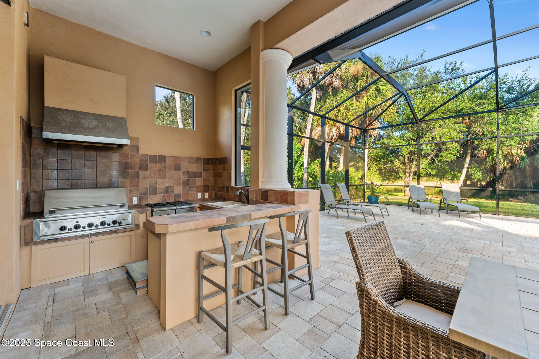 4447 Reseda Way Rockledge, FL 32955 - Photo 59 of 87 a kitchen with a stove a sink and cabinets