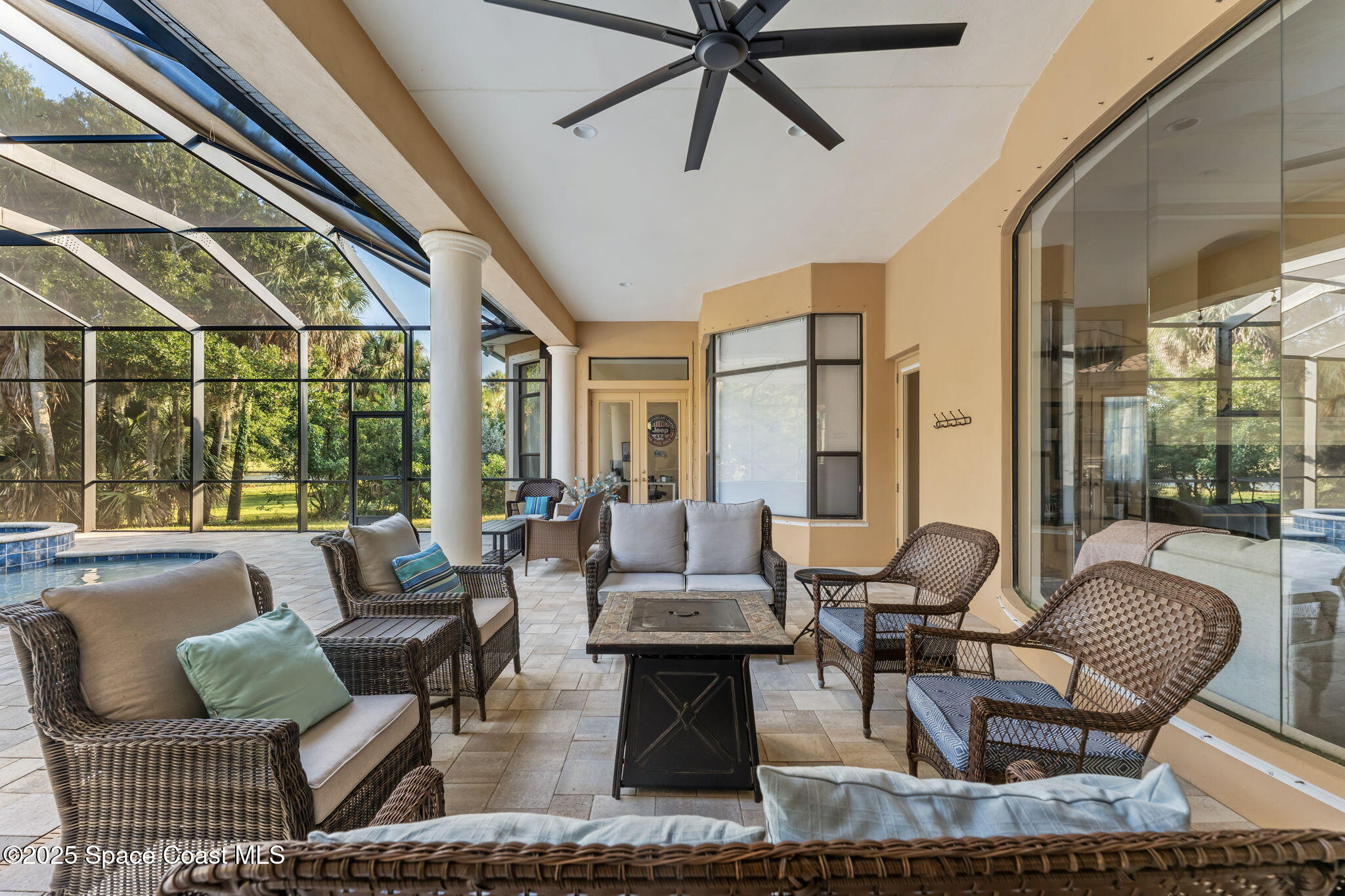 4447 Reseda Way Rockledge, FL 32955 - Photo 63 of 87 a living room with furniture and floor to ceiling windows