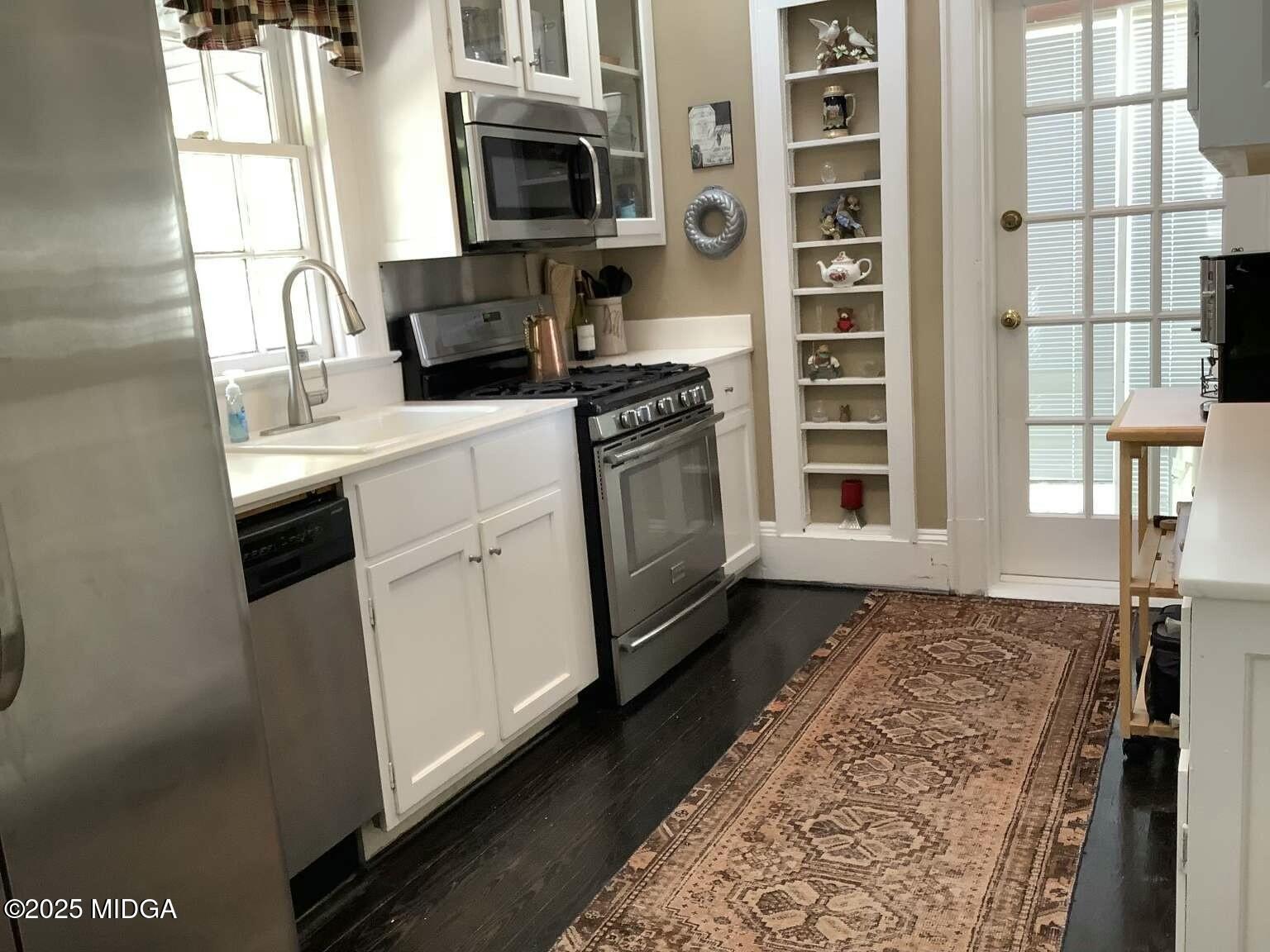 1057 Bond Street Macon, GA 31201 - Photo 24 of 27 a kitchen with stainless steel appliances a sink a stove and a microwave