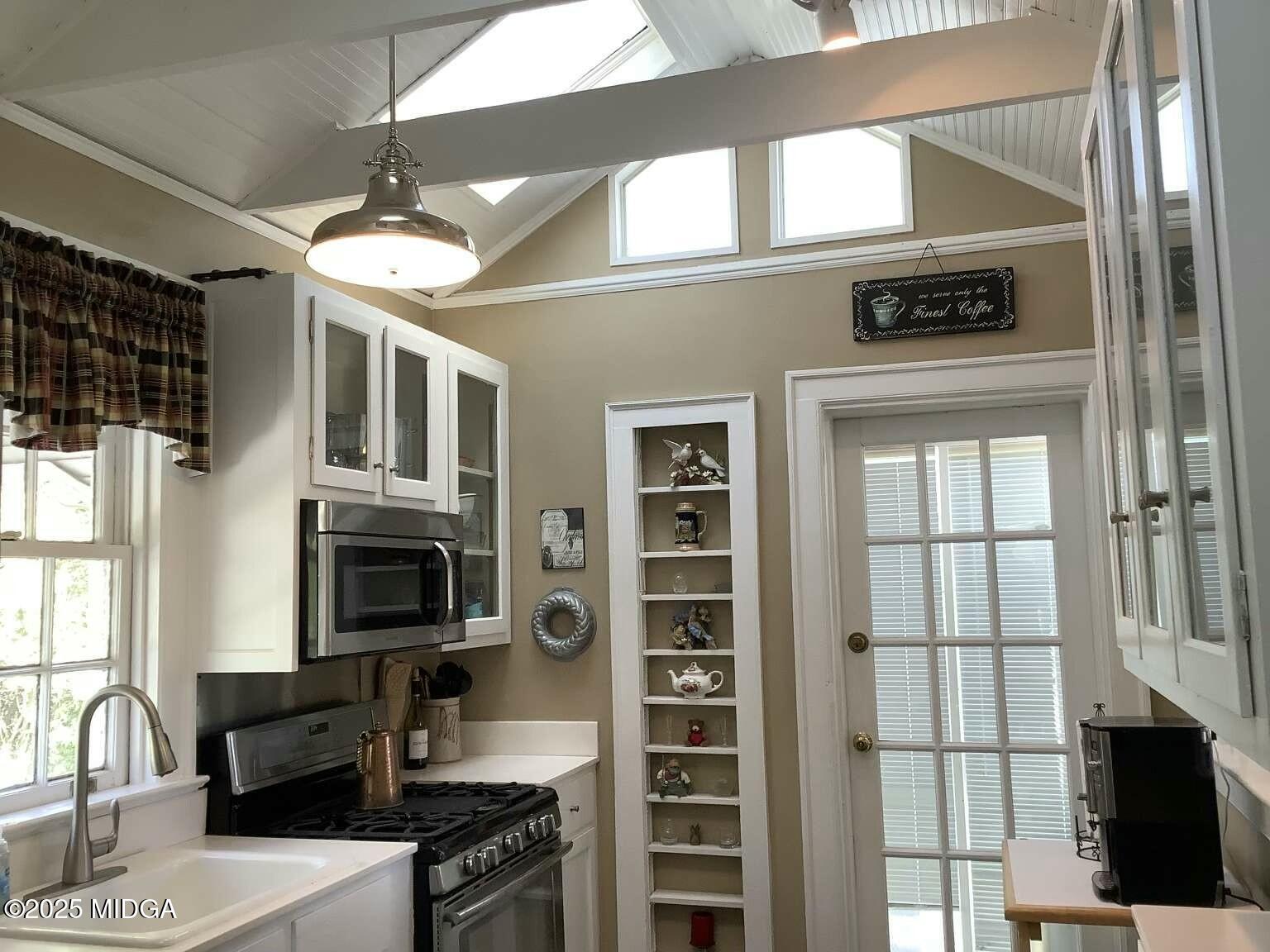 1057 Bond Street Macon, GA 31201 - Photo 25 of 27 a kitchen with stainless steel appliances granite countertop a stove and a microwave