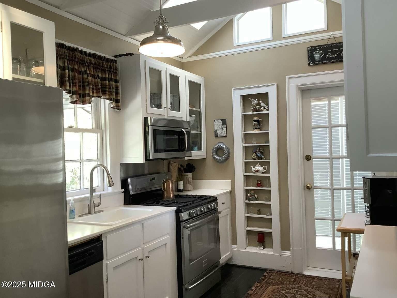 1057 Bond Street Macon, GA 31201 - Photo 27 of 27 a kitchen with stainless steel appliances a stove a sink and a microwave