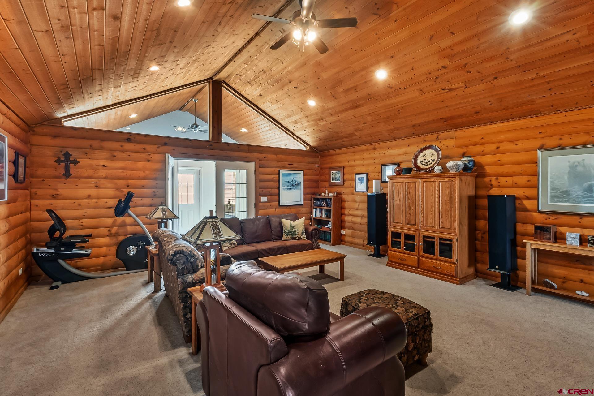 19632 E Road Delta, CO 81416 - Photo 11 of 45 a living room with furniture a flat screen tv and gym equipment