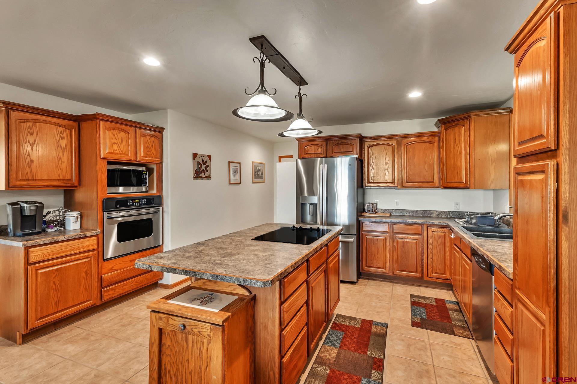 19632 E Road Delta, CO 81416 - Photo 15 of 45 a kitchen with stainless steel appliances granite countertop a sink a stove and a refrigerator