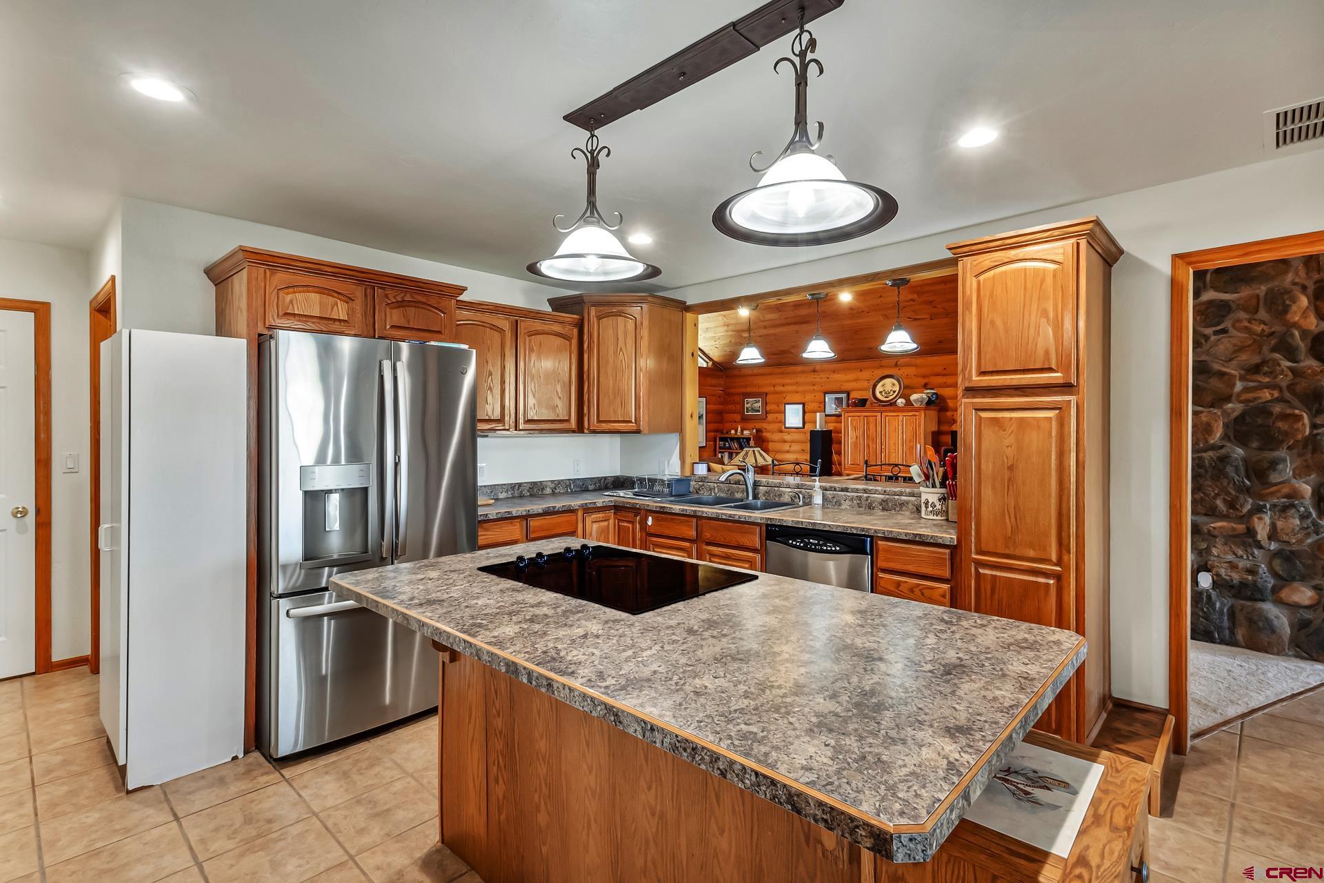 19632 E Road Delta, CO 81416 - Photo 16 of 45 a kitchen with stainless steel appliances granite countertop a sink a stove and a refrigerator