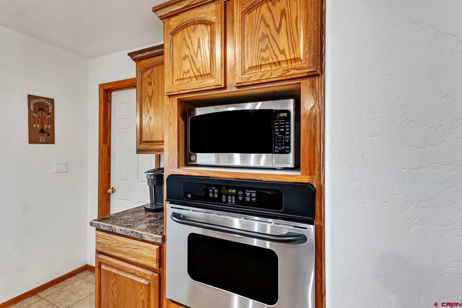 19632 E Road Delta, CO 81416 - Photo 18 of 45 a kitchen with granite countertop cabinets stainless steel appliances and wooden floor