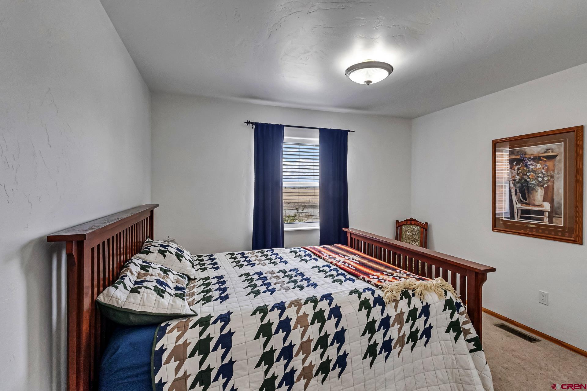 19632 E Road Delta, CO 81416 - Photo 21 of 45 a bed sitting in a bedroom next to a window