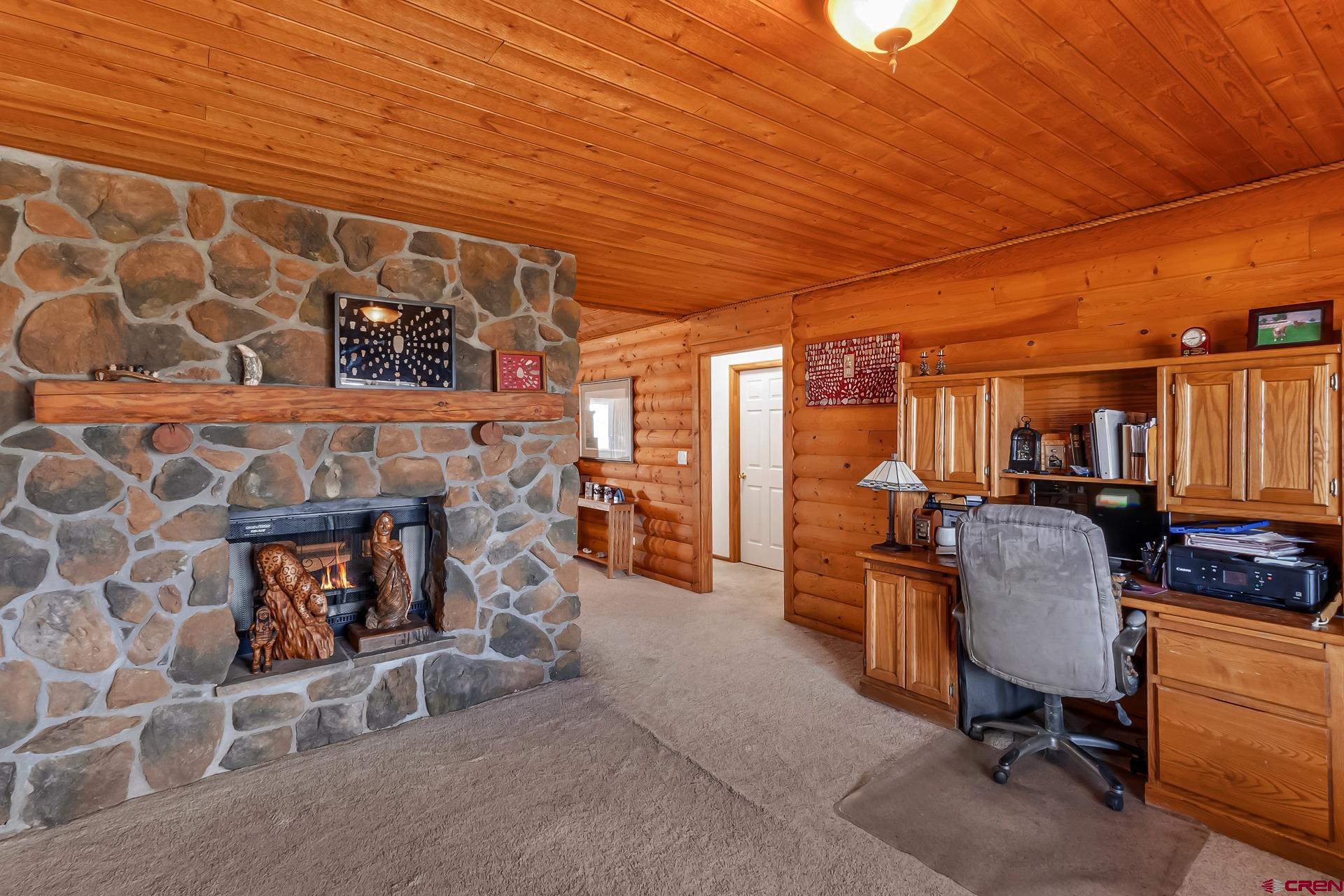 19632 E Road Delta, CO 81416 - Photo 26 of 45 a living room with furniture and a fireplace