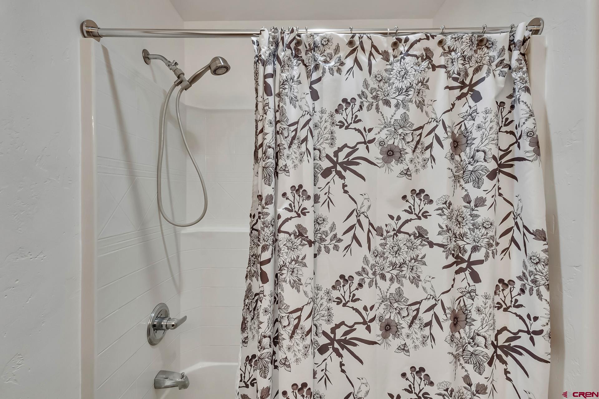 19632 E Road Delta, CO 81416 - Photo 34 of 45 a bathroom with a shower curtain and a shower curtain