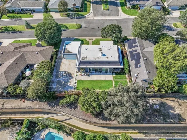 an aerial view of a house with garden space street and seating space