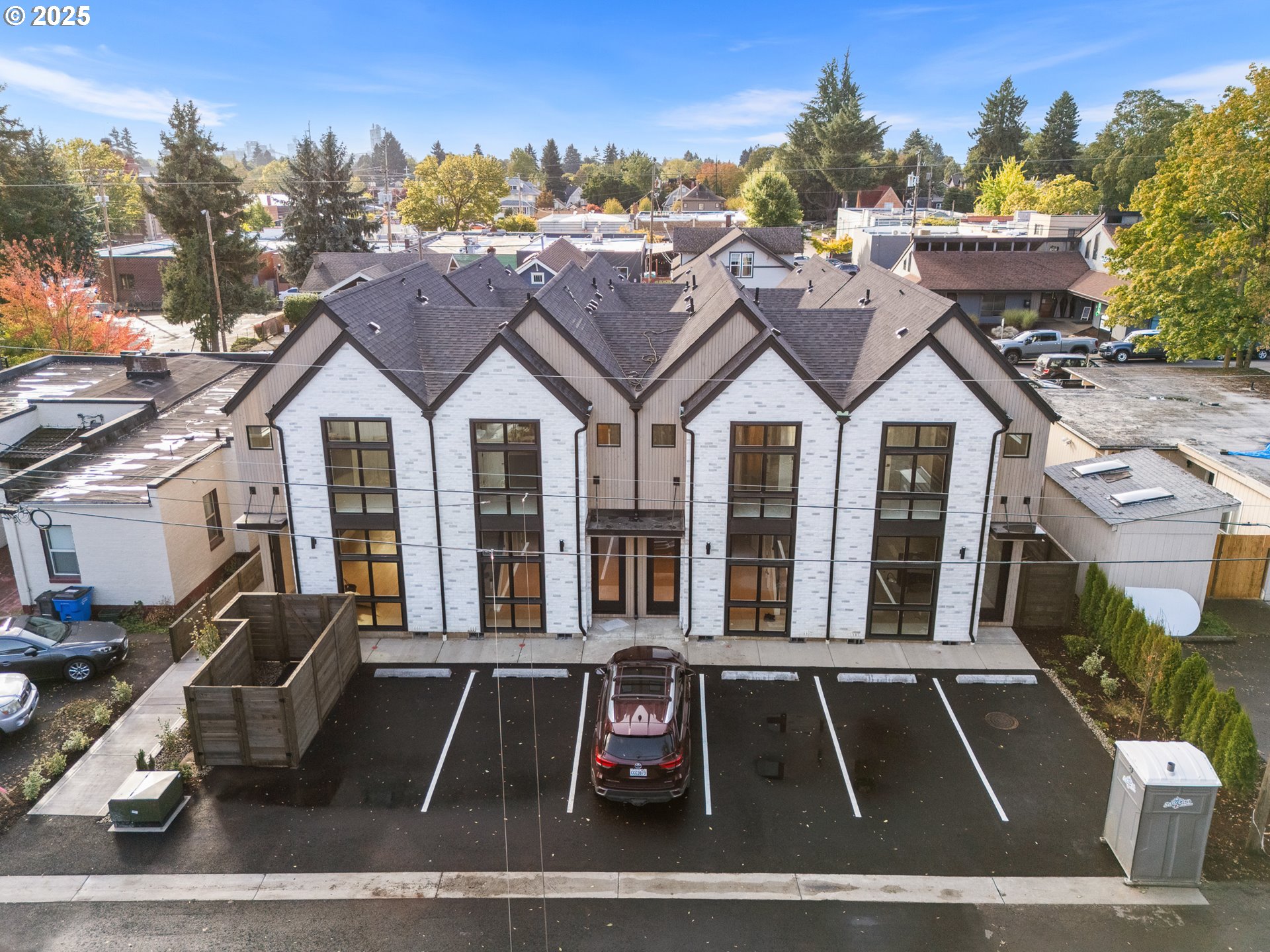 1911 Broadway Street, Unit 1 Vancouver, WA 98663 - Photo 24 of 25 a view of a white house with large windows and couches chairs