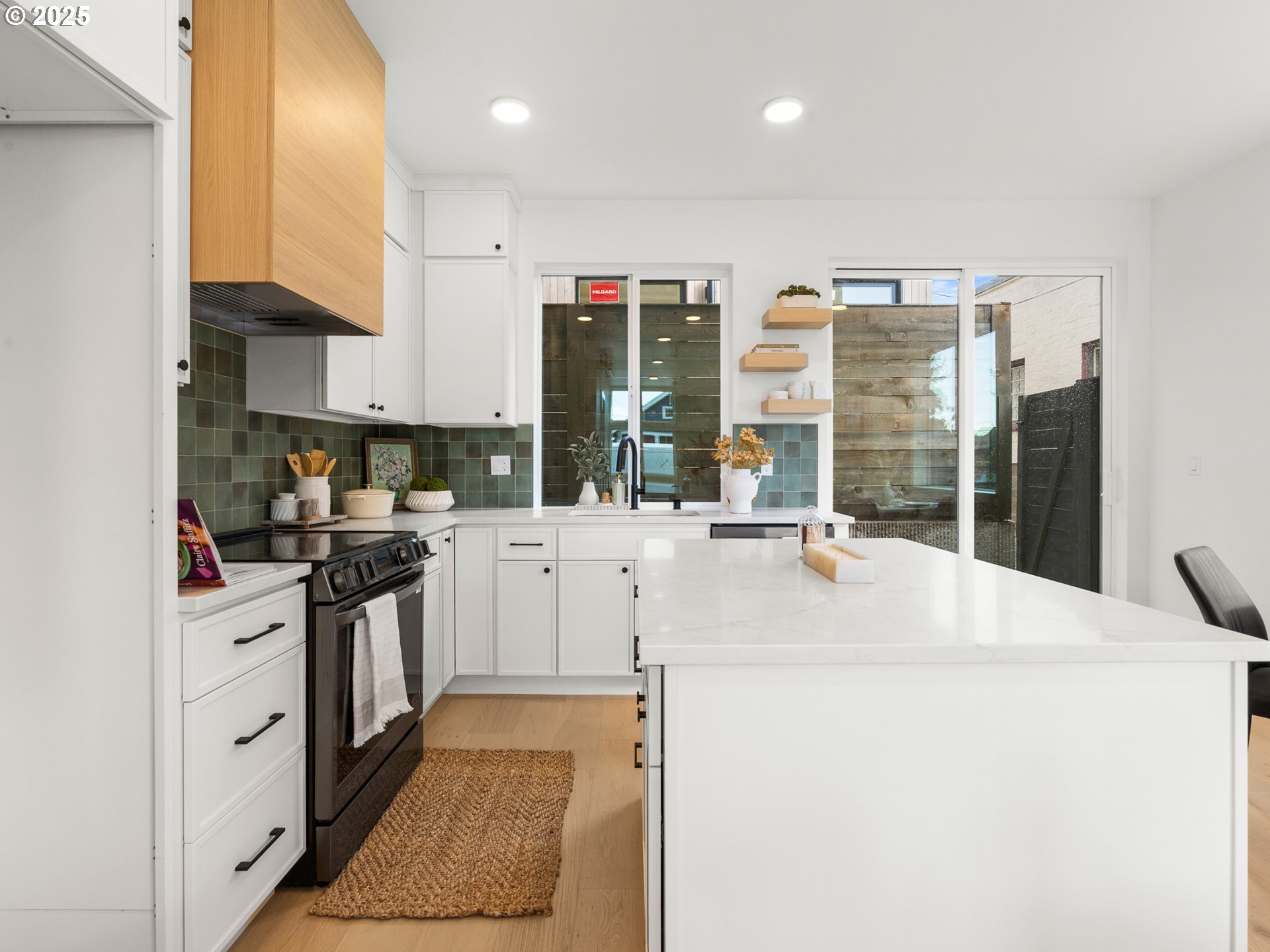 1911 Broadway Street, Unit 1 Vancouver, WA 98663 - Photo 6 of 25 a kitchen with stainless steel appliances kitchen island granite countertop a sink and cabinets