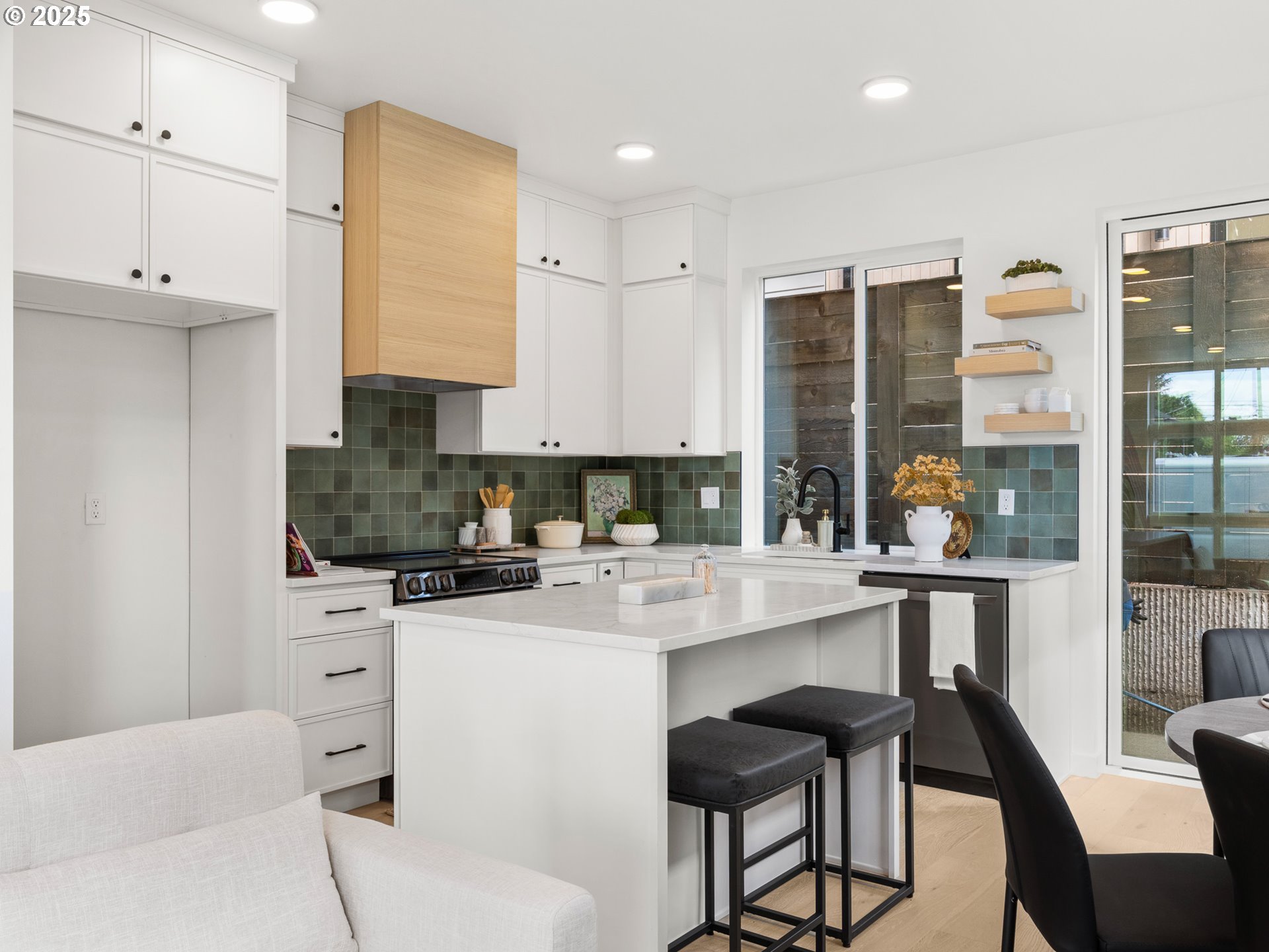 1911 Broadway Street, Unit 1 Vancouver, WA 98663 - Photo 7 of 25 a kitchen with a stove a refrigerator and a dining table with wooden floor