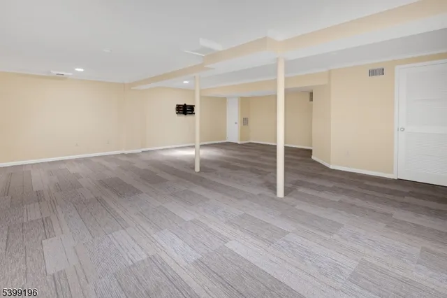 a view of a livingroom with wooden floor and cabinet