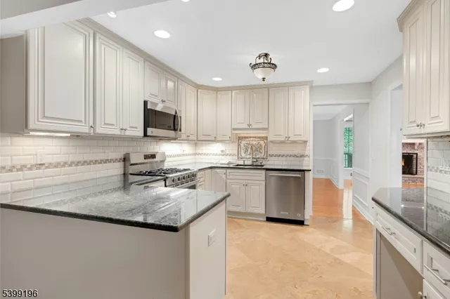 a kitchen with granite countertop a stove sink and cabinets