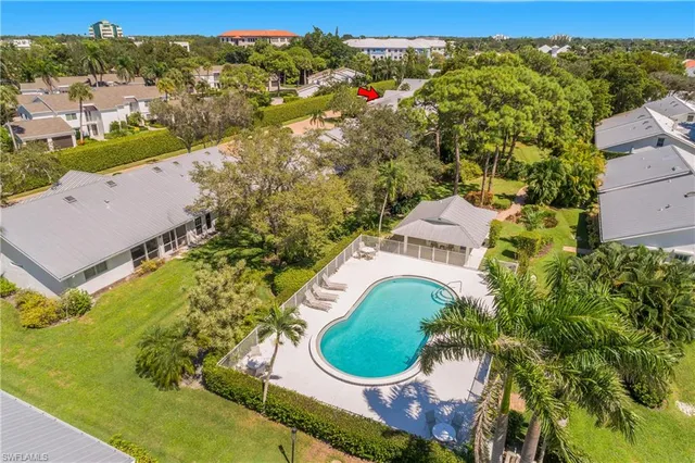 an aerial view of a house with a yard and lake view