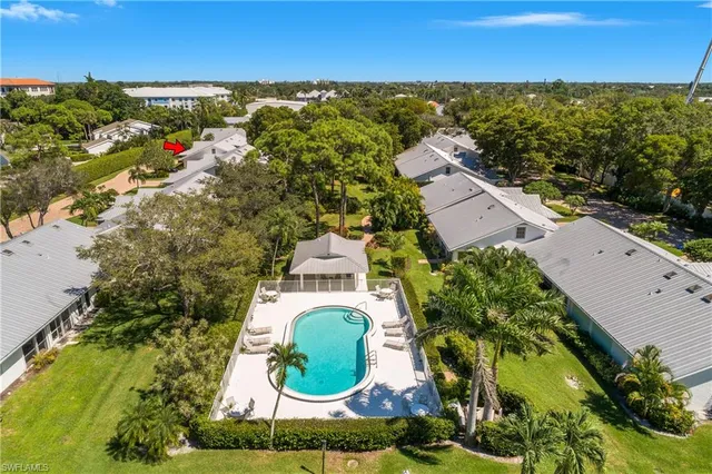 an aerial view of residential houses with outdoor space and swimming pool