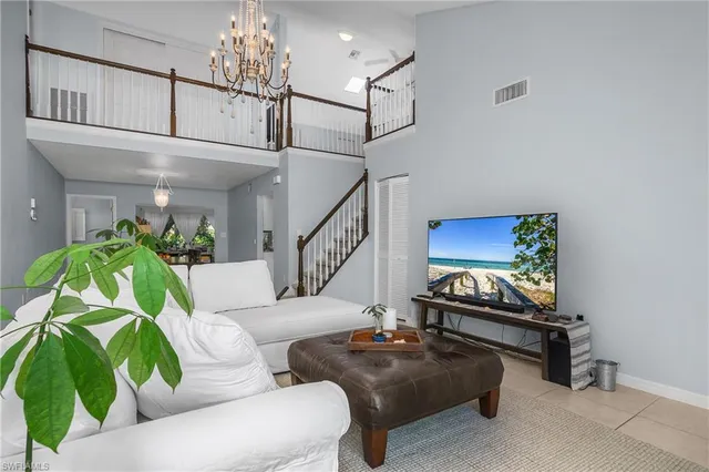 a living room with furniture and a chandelier