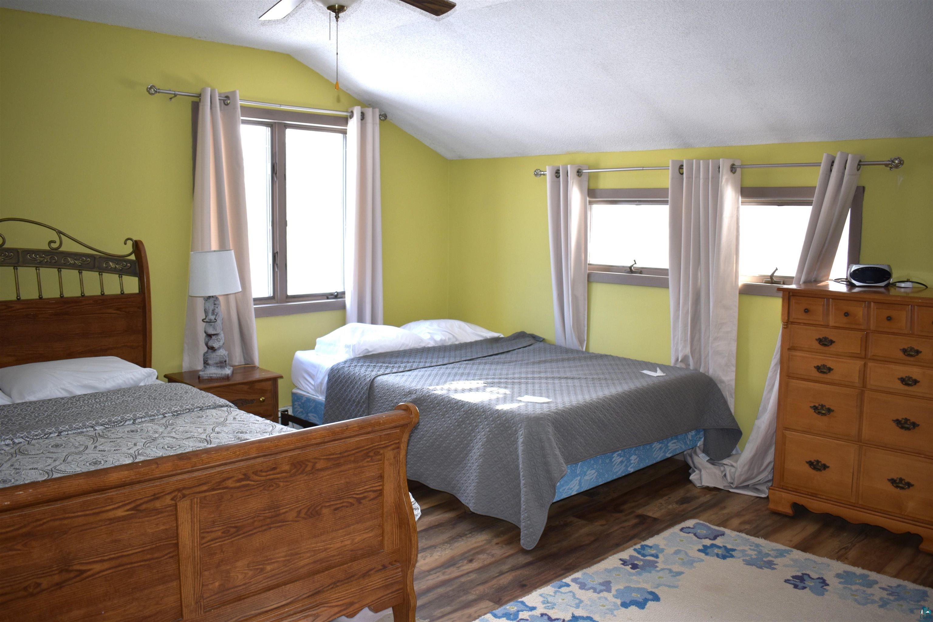 32410 McCulloch Road Washburn, WI 54891 - Photo 27 of 49 Bedroom featuring ceiling fan, dark hardwood / wood-style flooring, and vaulted ceiling