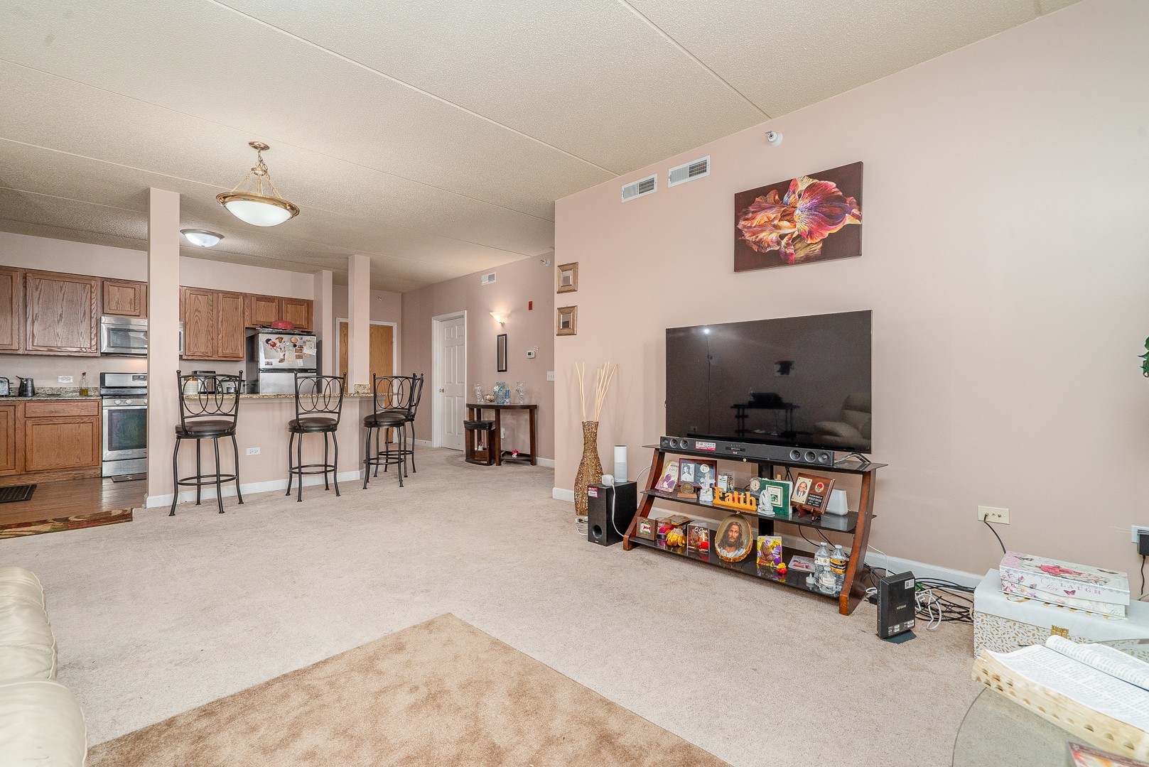 77 North Wolf Road, Unit 507 Northlake, IL 60164 - Photo 5 of 15 a living room with furniture and a flat screen tv