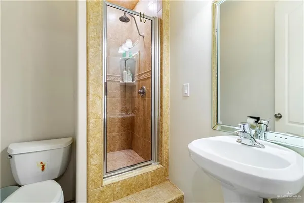 a bathroom with a sink toilet and shower