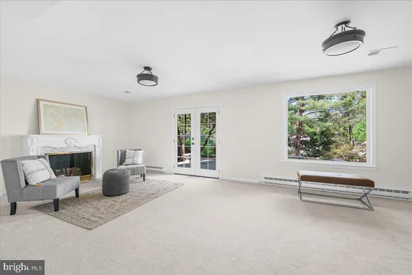 a living room with furniture a fireplace and a window