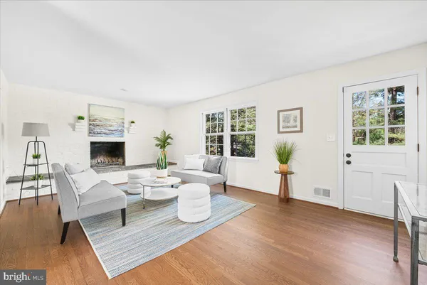 a living room with furniture a window and a fireplace