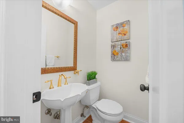 a bathroom with a sink mirror vanity and toilet