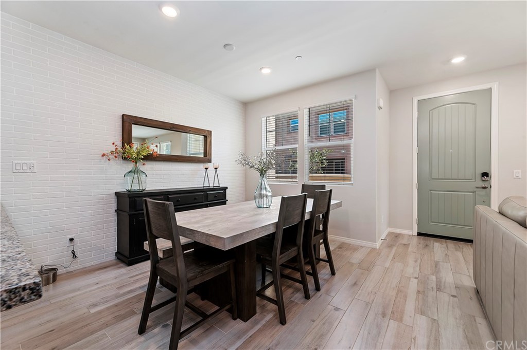 14557 Sienna Place Eastvale, CA 92880 - Photo 12 of 35 a view of a dining room with furniture and wooden floor