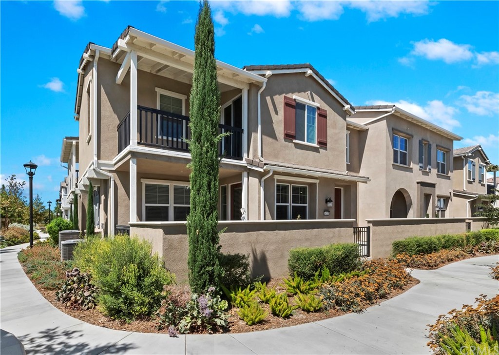 14557 Sienna Place Eastvale, CA 92880 - Photo 2 of 35 front view of a house with a yard