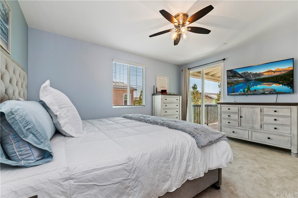 14557 Sienna Place Eastvale, CA 92880 - Photo 25 of 35 a bedroom with a bed and a flat screen tv